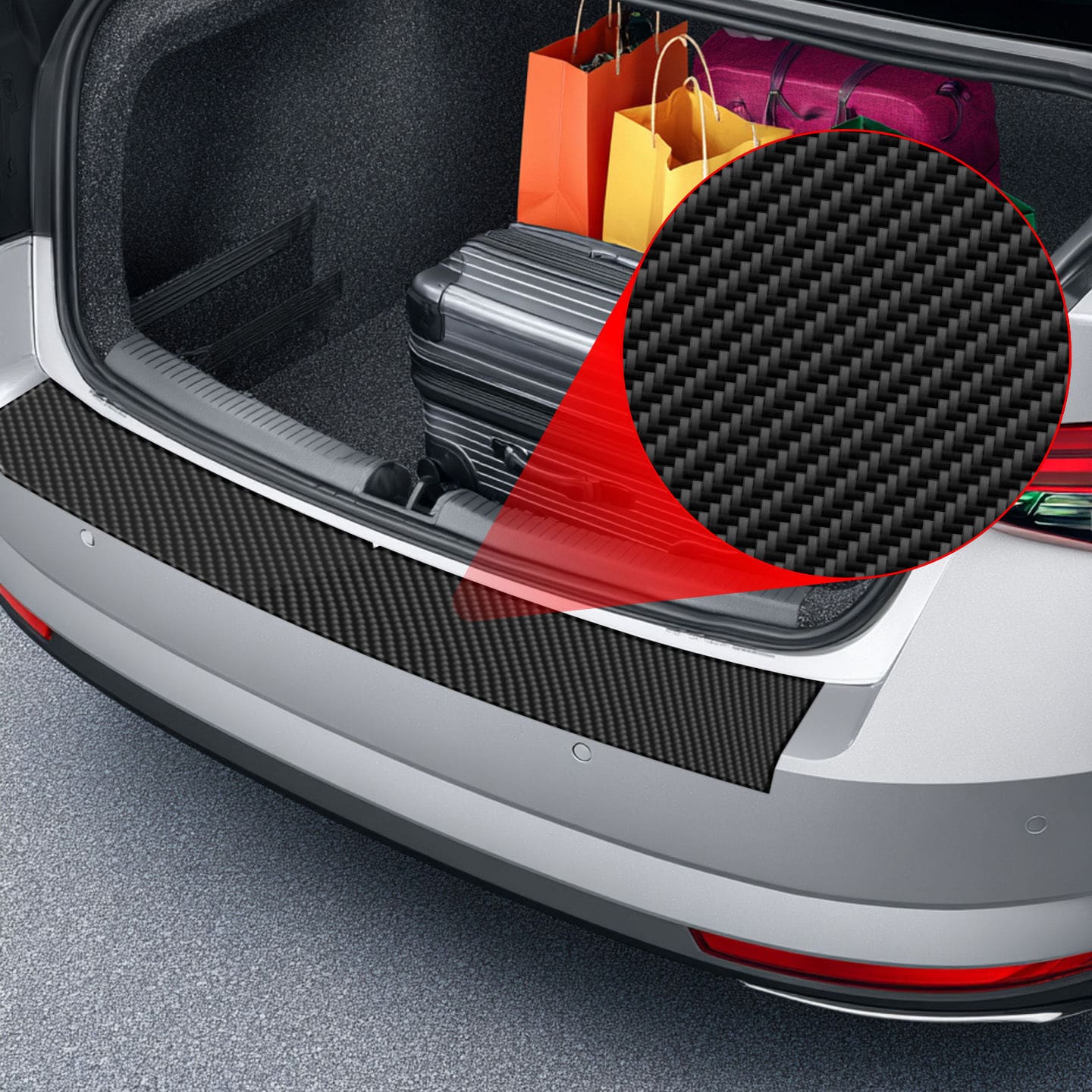 Car trunk with shopping bags and suitcase, featuring a GrizzProtector Kohlenstoff Schutzfolie MG HS (2024-2025) on the bumper.