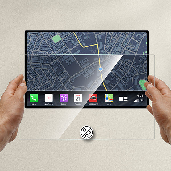 Hands hold a GrizzProtector Displayschutzfolie for BYD Atto 3 15,6" (2022-2025), showing a map and app icons.