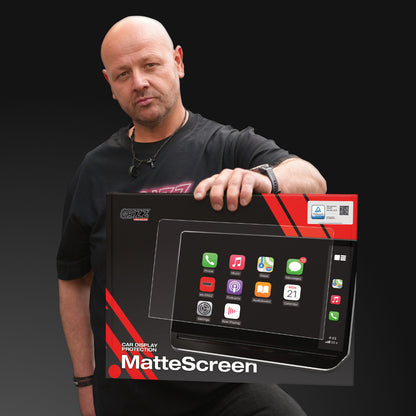 Bald man in black shirt holding GrizzProtector Navigation Displayschutzfolie for BYD Atto 3 against dark background.